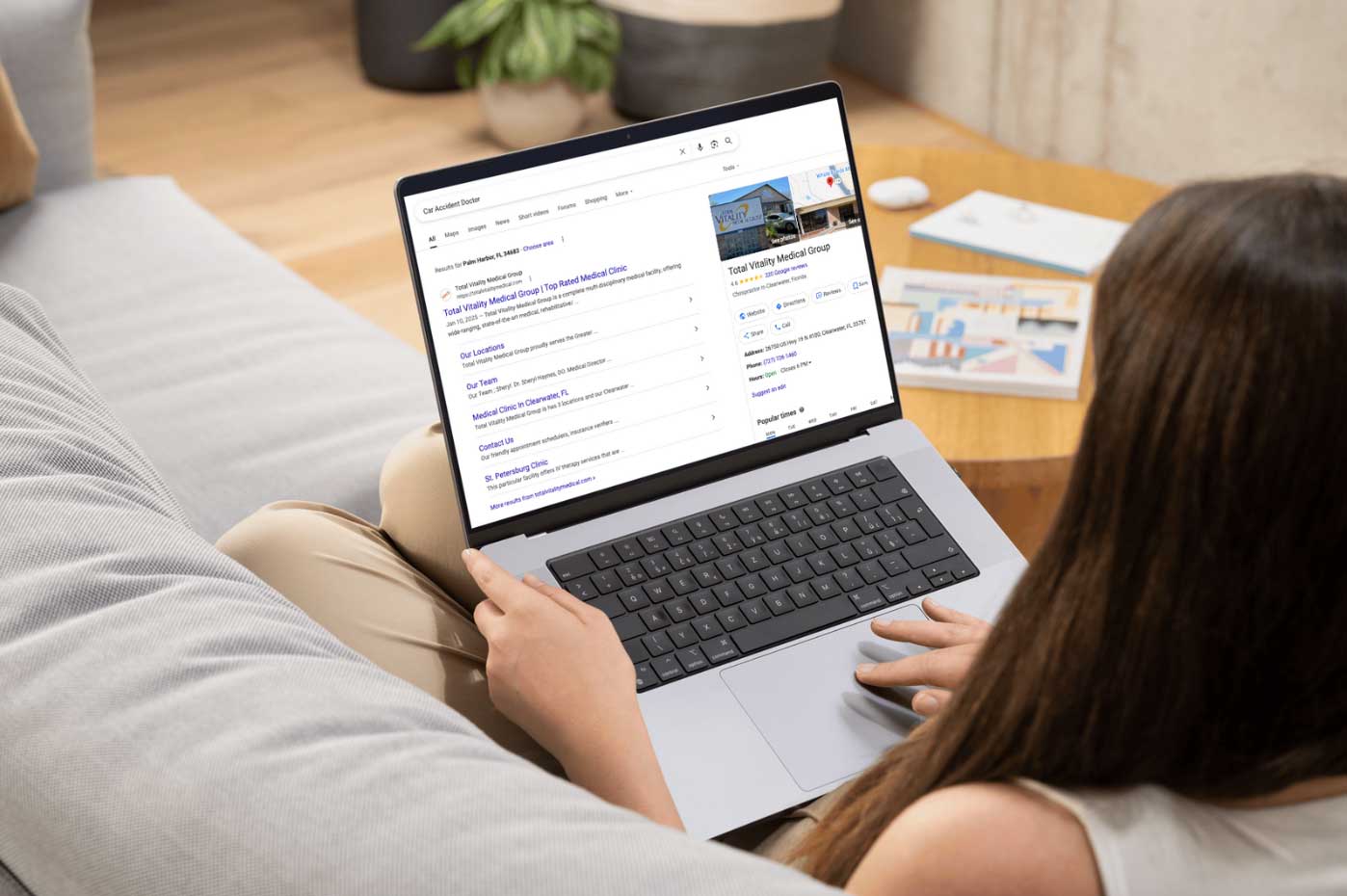 Person using a laptop to search for local medical services, highlighting NAP consistency for local SEO in Tampa.