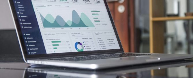 Laptop displaying digital marketing analytics and performance metrics, showcasing graphs and data visualizations relevant to web design and SEO strategies.